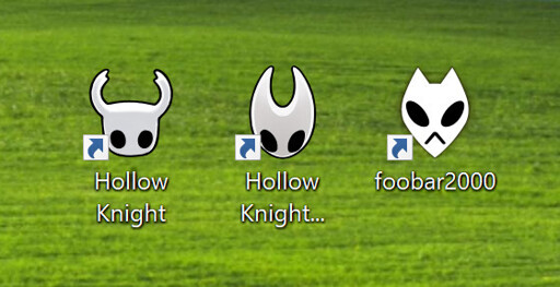 The PC icons for the video games Hollow Knight and Silksong, both featuring the white pointy masks with jet black eyes that the protagonists wear, followed by the icon of the music playng app Foobar2000, which also resembles the design of their white pointy masks