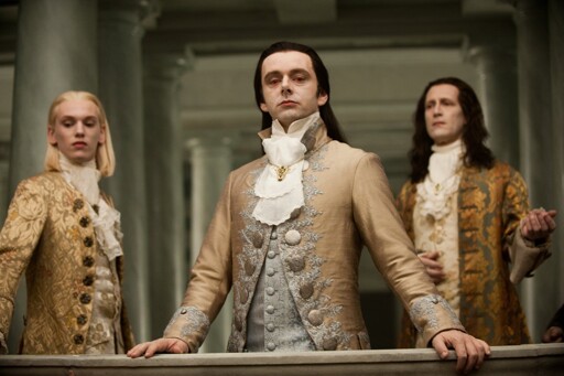 Three aristocrats on a balcony looking down with disdain 