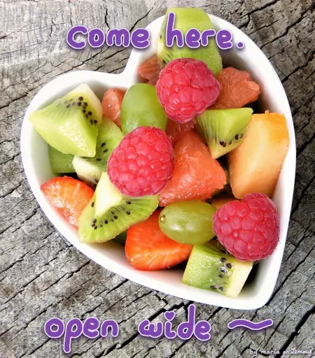 photo of a heart-shyped bowl filled with fruits and berries. specifically: kiwi pieces, raspberries, grapes, strawberries pieces and some melon pieces. they look soft and tasty together. text overtop says "come here. open wide!". bottom right says "by maria on lemmy"